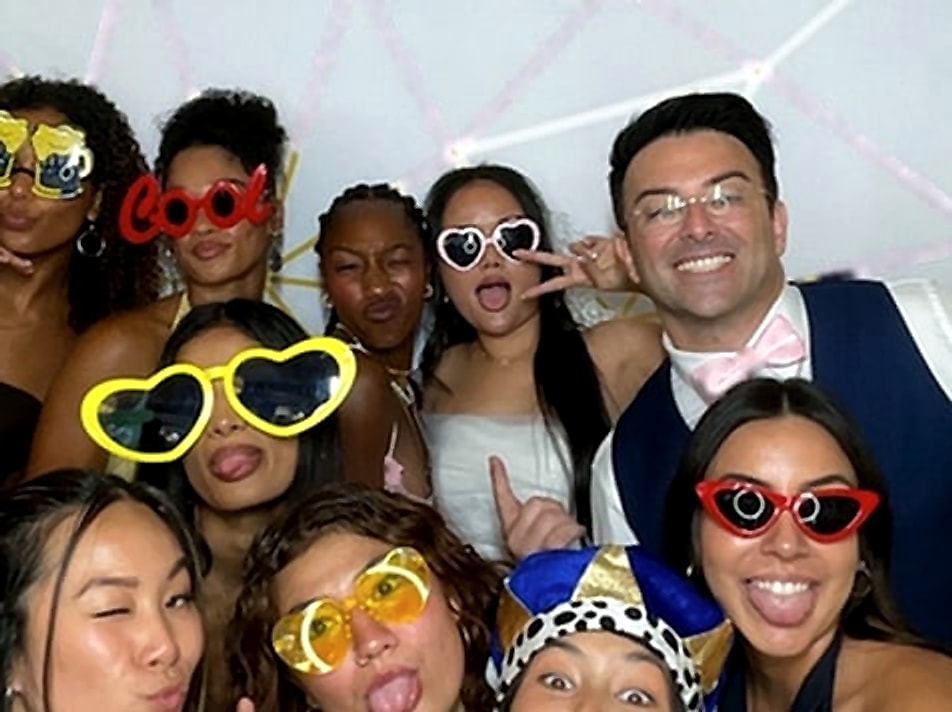 Bridesmaids and the groom laughing in a GLITZBX group photo